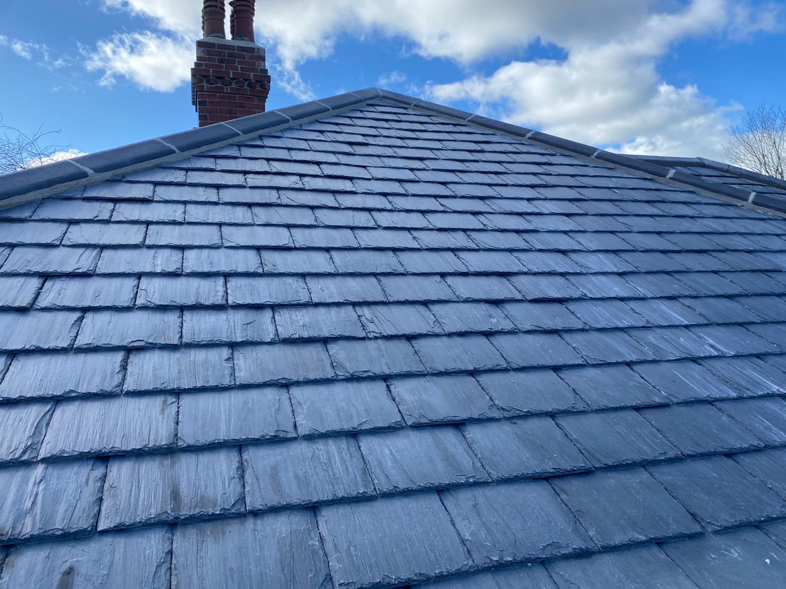 Grey slate roof with new ridge and chimney completed by EJL Roofing