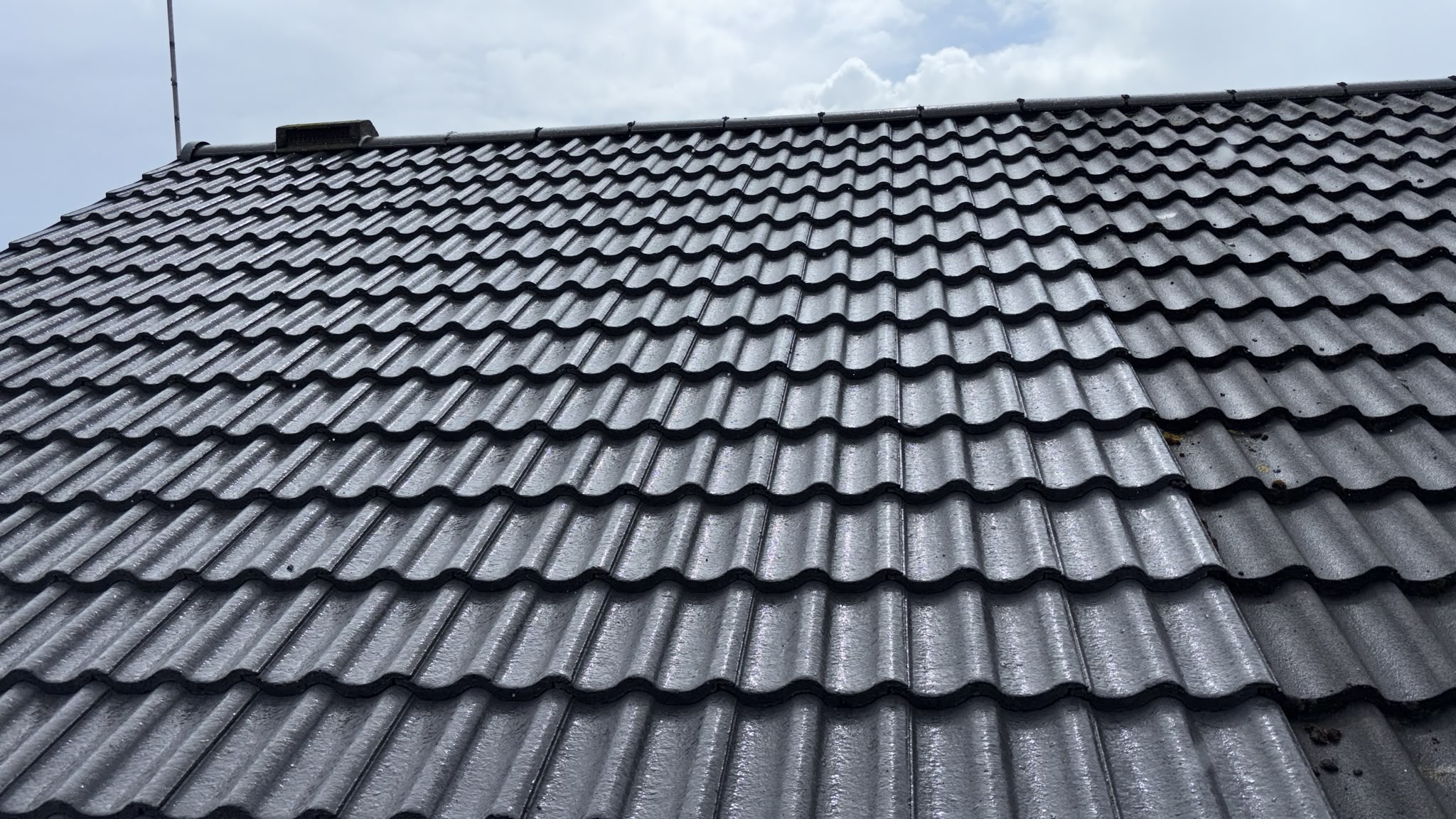 A finished grey concrete tile roof, ridge to eaves, on a York home