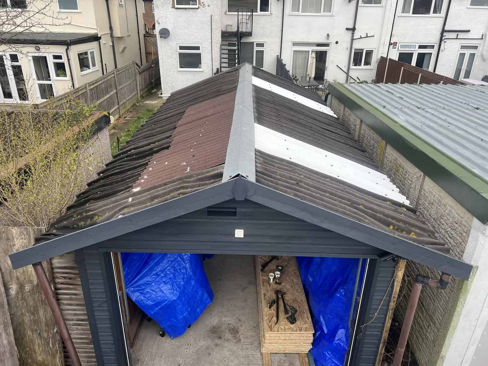 Garage roof made safe with tarpaulin after storm damage