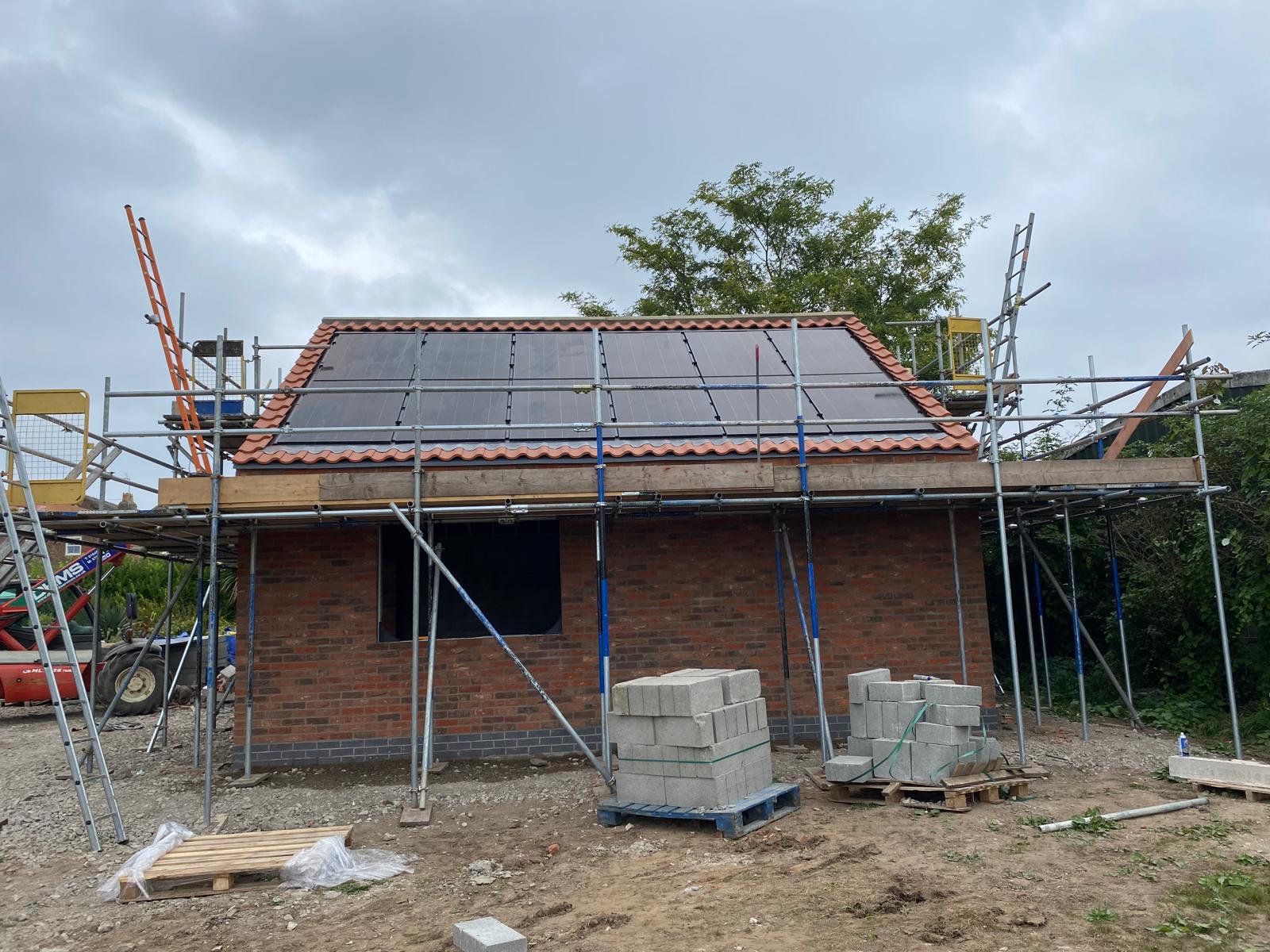 On-roof solar panels on the tiled roof of a brick new build in York
