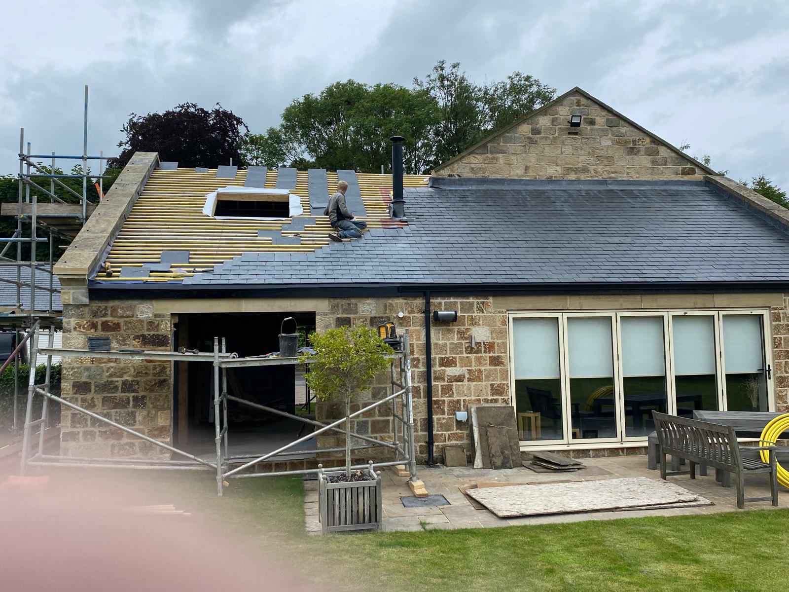 New slate roof being installed on a stone extension on the outskirts of York